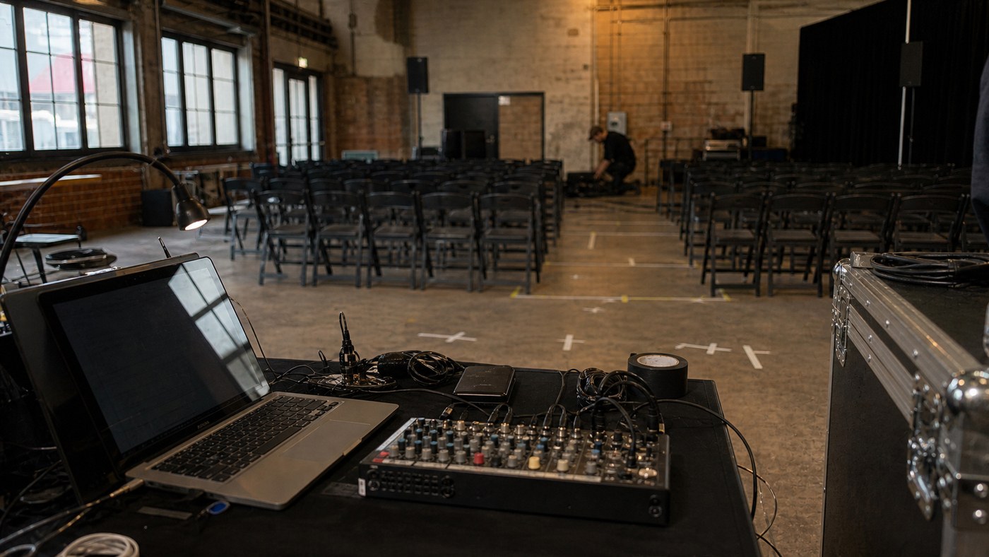 Quiet technical run-through before a product launch in an industrial venue